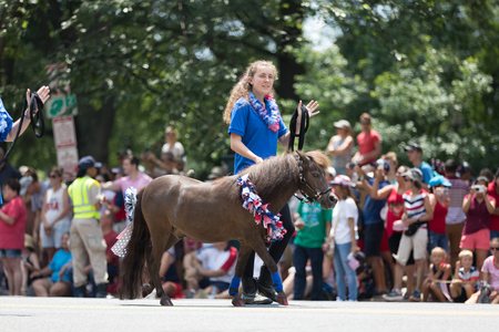 Washington, D.C., USA - July 4, 2018, The National Independence Day Parade, women walking mini horses down constitution avenueのeditorial素材