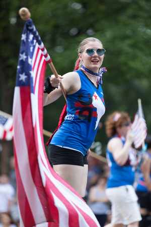 Washington, D.C., USA - July 4, 2018, The National Independence Day Parade, The DC Roller Girls, skating and carrying american flags down constitution avenueのeditorial素材