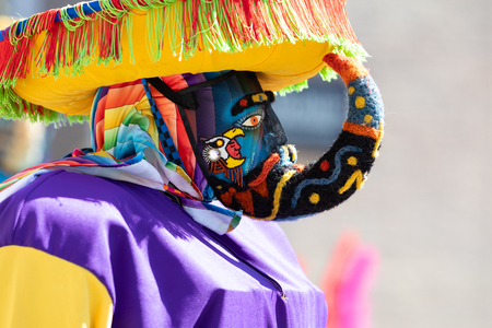 Chicago, Illinois, USA - September 15, 2018: Pilsen Mexican Independence Day Parade, Mexican man wearing traditional clothing and a full head mask, going down the streetのeditorial素材
