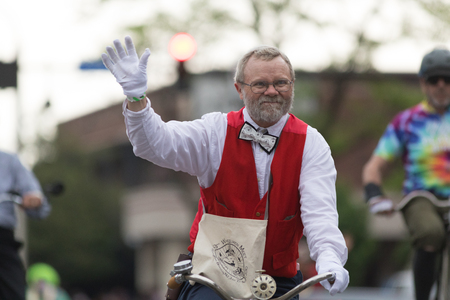 Louisville, Kentucky, USA - May 03, 2018: The Pegasus Parade, Man riding bicycle down W Broadway during the paradeのeditorial素材