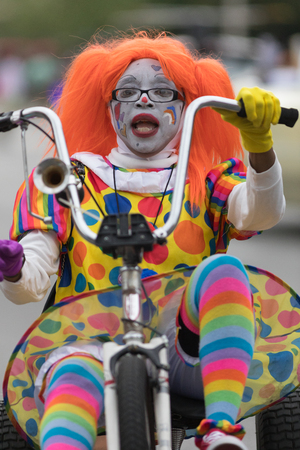 Louisville, Kentucky, USA - May 03, 2018: The Pegasus Parade, A clown riding a tricycle down W Broadway during the paradeのeditorial素材