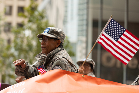 Houston, Texas, USA - November 11, 2018: The American Heroes Parade, Vietnam veteran on a float with the american flag, during the paradeのeditorial素材