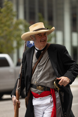 Houston, Texas, USA - November 11, 2018: The American Heroes Parade, Men wearing early Settlers outfits, and carrying Muskets, walking down the streetのeditorial素材