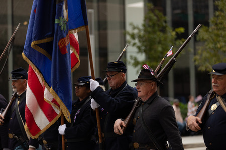 Houston, Texas, USA - November 11, 2018: The American Heroes Parade, Men using civil war union soldier uniforms and carrying muskets and american flags, marching down the roadのeditorial素材