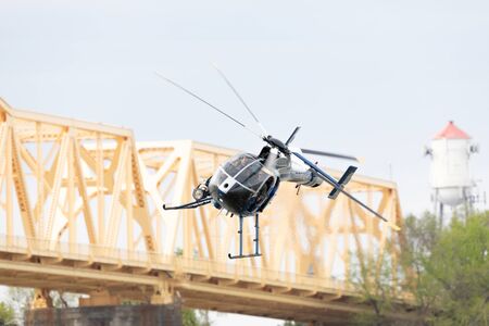 Louisville, Kentucky, USA - April 13, 2019: Thunder Over Louisville, Louisville Metro Police Department LMPD Air Operations MD 520N performing a recue demostration on the Ohio Riverのeditorial素材