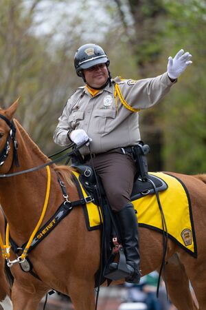 Wilmington, North Carolina, USA - April 6, 2019: The North CarolinaAzalea Festival, Sheriff waving...