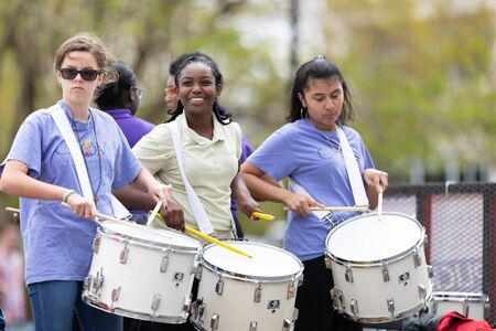 Wilmington, North Carolina, USA - April 6, 2019: The North CarolinaAzalea Festival, Members of the Girls Leadership Academy of Wilmington, playing the drums at the paradeのeditorial素材