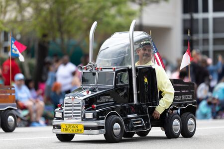 Wilmington, North Carolina, USA - April 6, 2019: The North CarolinaAzalea Festival, Members of Sudan Truckers, driving mini trucks down 3rd street at the paradeのeditorial素材