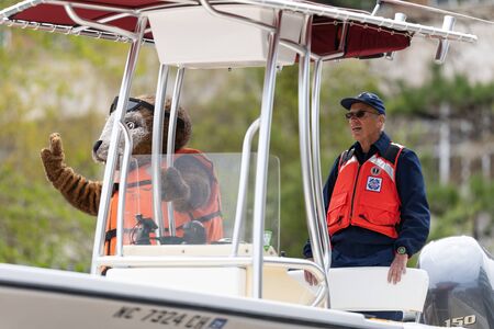 Wilmington, North Carolina, USA - April 6, 2019: The North Carolina
Azalea Festival, Members of the U.S. Coast Guard, Auxiliary, on a boat going down 3rd streetのeditorial素材