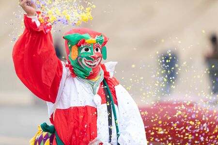 St. Louis, Missouri, USA - March 2, 2019: Bud Light Grand Parade, Person in a jester costume throwing confetti into the air during the paradeのeditorial素材