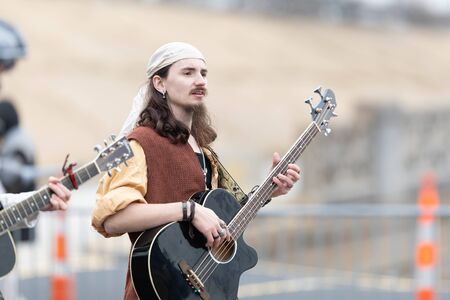 St. Louis, Missouri, USA - March 2, 2019: Bud Light Grand Parade, Man wearing a retro outfit playing the guitar, walking down 7th streetのeditorial素材