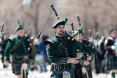 Chicago, Illinois, USA - March 16, 2019: St. Patrick's Day Parade, Members of the Shannon Rovers Pipe Band performing at the paradeのeditorial素材