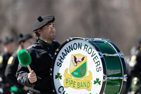 Chicago, Illinois, USA - March 16, 2019: St. Patrick's Day Parade, Members of the Shannon Rovers Pipe Band performing at the paradeのeditorial素材