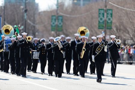 Chicago, Illinois, USA - March 16, 2019: St. Patrick's Day Parade, Members of the United States Navy marching band performing at the paradeのeditorial素材