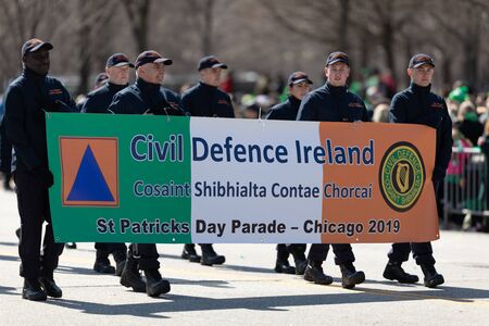 Chicago, Illinois, USA - March 16, 2019: St. Patrick's Day Parade, Members of the Civil Defence Ireland marching down Columbus driveのeditorial素材