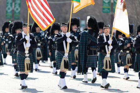 Chicago, Illinois, USA - March 16, 2019: St. Patrick's Day Parade, The Bagpipes and Drums of the Emerald Society Chicago Police Department performing at the paradeのeditorial素材