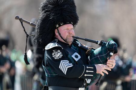 Chicago, Illinois, USA - March 16, 2019: St. Patrick's Day Parade, The Bagpipes and Drums of the Emerald Society Chicago Police Department performing at the paradeのeditorial素材