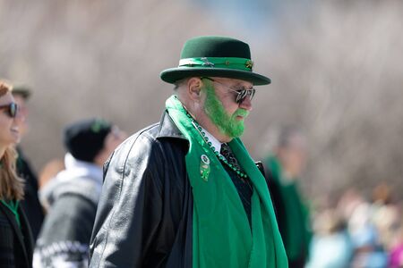 Chicago, Illinois, USA - March 16, 2019: St. Patrick's Day Parade, Man with his beard painted green and using an irish hat walking down columbus driveのeditorial素材