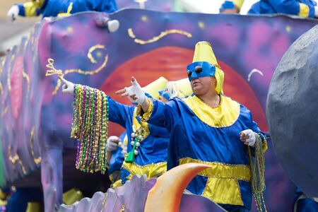 New Orleans, Louisiana, USA - February 23, 2019: Mardi Gras Parade, Man wearing traditional clothing, throwing beads to the spectators during the mardi gras paradeのeditorial素材