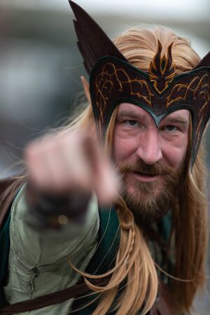 New Orleans, Louisiana, USA - February 23, 2019: Mardi Gras Parade, Man dress up as an Elf, looks and points at the camera during the paradeのeditorial素材