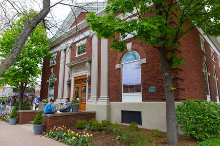 Holland, Michigan, USA - May 11, 2019: Couple eating lunch infront of the Woman's Literary Club building during the tulip time festivalのeditorial素材