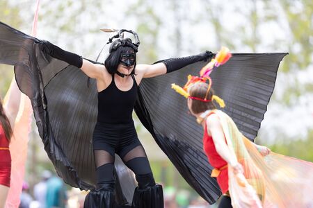Cleveland, Ohio, USA - June 8, 2019: Parade the Circle, women on stilts with outfits with wings at the paradeのeditorial素材
