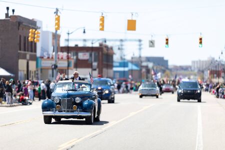 Benton Harbor, Michigan, USA - May 4, 2019: Blossomtime Festival Grand Floral Parade, Classic car carrying the parades grand marshall, retired whirpool chairmanのeditorial素材