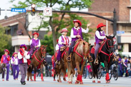 Louisville, Kentucky, USA - May 2, 2019: The Pegasus Parade, Members of the Red Hats & Purple Chaps, riding horses, during the paradeのeditorial素材