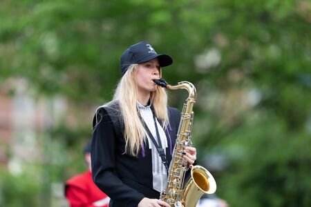Louisville, Kentucky, USA - May 2, 2019: The Pegasus Parade, Young woman member of the All-Star Band, playing the saxophone during the paradeのeditorial素材