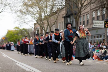 Holland, Michigan, USA - May 11, 2019: Tulip Time Festival, Young women wearing traditional Dutch Clothing dancing in the streets of Holland, Michigan during the Festivalのeditorial素材