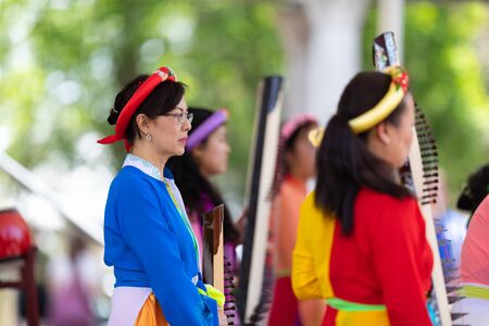 Columbus, Ohio, USA - May 26, 2019: Columbus Asian Festival, Franklin Park, vietnamese woman wearing traditional clothing playing the Dan Tranh at the asian festivalのeditorial素材