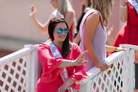 Buckhannon, West Virginia, USA - May 18, 2019: Strawberry Festival, Beauty Contestants, on float, going down Main Street, smiling, waving at spectators, during the paradeのeditorial素材
