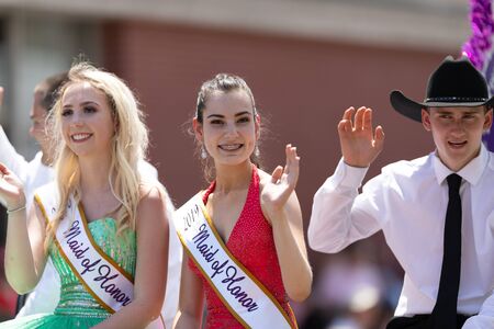 Buckhannon, West Virginia, USA - May 18, 2019: Strawberry Festival, Beauty Contestants, on float, going down Main Street, smiling, waving at spectators, during the paradeのeditorial素材