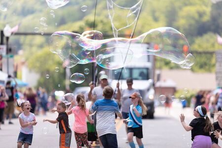 Buckhannon, West Virginia, USA - May 18, 2019: Strawberry Festival, Man creating larg bubbles for...