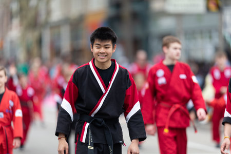 Holland, Michigan, USA - May 11, 2019: Tulip Time Parade, Display by school of martial arts on the street during the paradeのeditorial素材