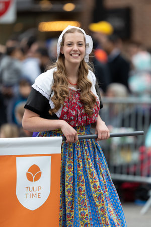 Holland, Michigan, USA - May 11, 2019: Tulip Time Parade, Woman smiles, wearing a traditional dutch outfit during the paradeのeditorial素材