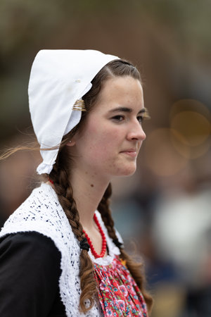Holland, Michigan, USA - May 11, 2019: Tulip Time Parade, Woman smiles, wearing a traditional dutch outfit during the paradeのeditorial素材