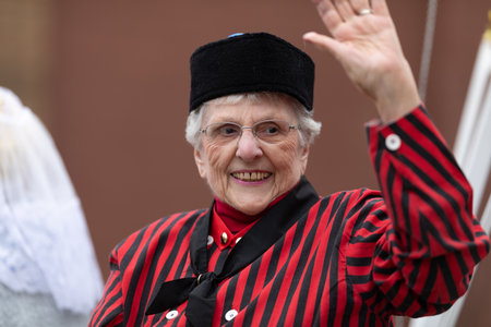 Holland, Michigan, USA - May 11, 2019: Tulip Time Parade, Woman smiles, wearing a traditional dutch outfit during the paradeのeditorial素材