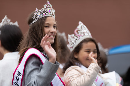 Holland, Michigan, USA - May 11, 2019: Tulip Time Parade, Beauty queens, smiling and waving at the spectators, being transported on the back of a car during the paradeのeditorial素材