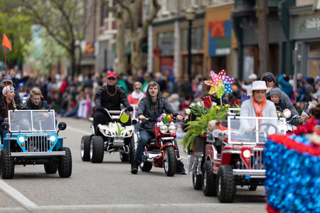 Holland, Michigan, USA - May 11, 2019: Tulip Time Parade, Men and women riding motorcycles and mini cars down the road during the paradeのeditorial素材