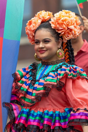 Chicago, Illinois, USA - September 8, 2019: 26th Street Mexican Independence Parade, Young woman wearing a traditional dress, with flowers on her head, smilingのeditorial素材