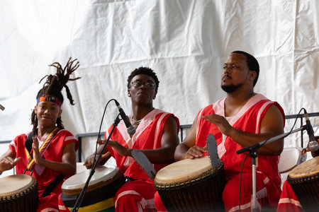 St. Louis, Missouri, USA - August 24, 2019: Festival of Nations, Tower Grove Park, Members of the Sunshine Community Performance Ensemble, wearing traditional clothing, performing traditional music dances from West Africaのeditorial素材