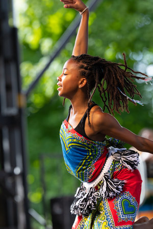 St. Louis, Missouri, USA - August 24, 2019: Festival of Nations, Tower Grove Park, Members of the Sunshine Community Performance Ensemble, wearing traditional clothing, performing traditional music dances from West Africaのeditorial素材