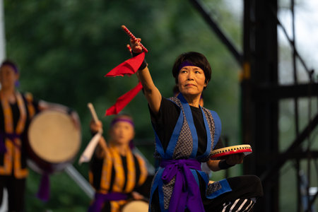St. Louis, Missouri, USA - August 25, 2019: Festival of Nations, Tower Grove Park, Members of the St. Louis Eisa Okinawa Kenjin-Kai, wearing traditional clothing, performing traditional Okinawan, Japanese drum danceのeditorial素材