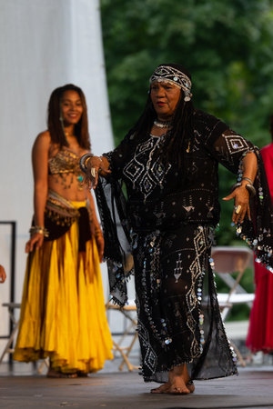 St. Louis, Missouri, USA - August 25, 2019: Festival of Nations, Tower Grove Park, members of the Tribe Azuka, wearing traditional clothing, performing traditional African dancesのeditorial素材