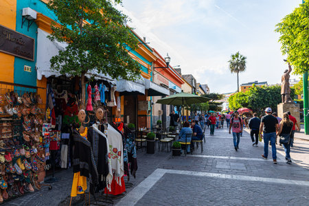 San Pedro Tlaquepaque, Jalisco, Mexico - November 23, 2019: Locals and Tourists exploring the restaurants and shops on Independencia Streetのeditorial素材