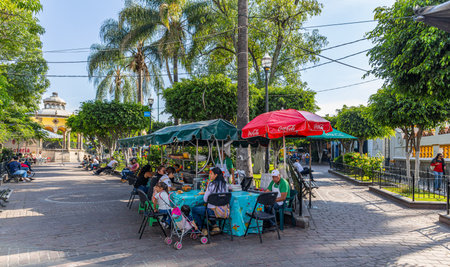 San Pedro Tlaquepaque, Jalisco, Mexico - November 23, 2019: Tourists, Locals and street vendors at the hidalgo gardenのeditorial素材