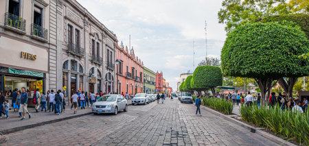 Santiago de Queretaro, Queretaro, Mexico - November 24, 2019: Tourists and locals exploring the shops and restaurants at Benito Juarez street, by the Zenea Gardenのeditorial素材