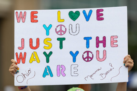 Cincinnati, Ohio, USA - June 22, 2019: The Cincinnati Pride Parade, Woman holding sign that says "we love you just the way you are"のeditorial素材