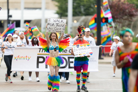 Cincinnati, Ohio, USA - June 22, 2019: The Cincinnati Pride Parade, Man and woman carrying signs...